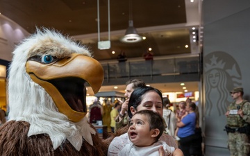 The AFN &quot;Eagle&quot; poses with AAFES patrons