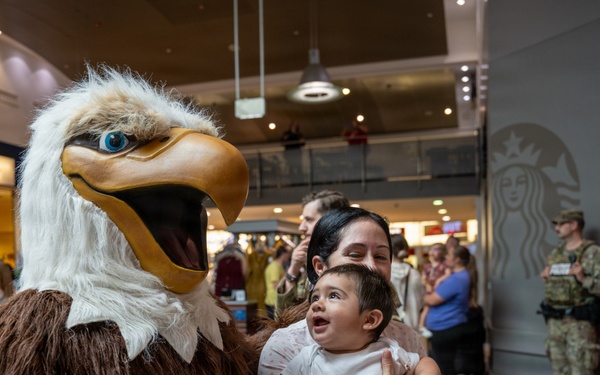 The AFN &quot;Eagle&quot; poses with AAFES patrons