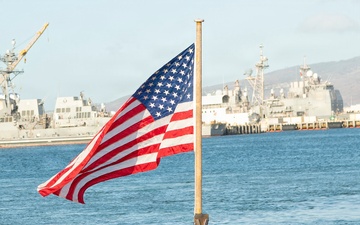 Sailor Honors Naval Tradition by Raising the Colors