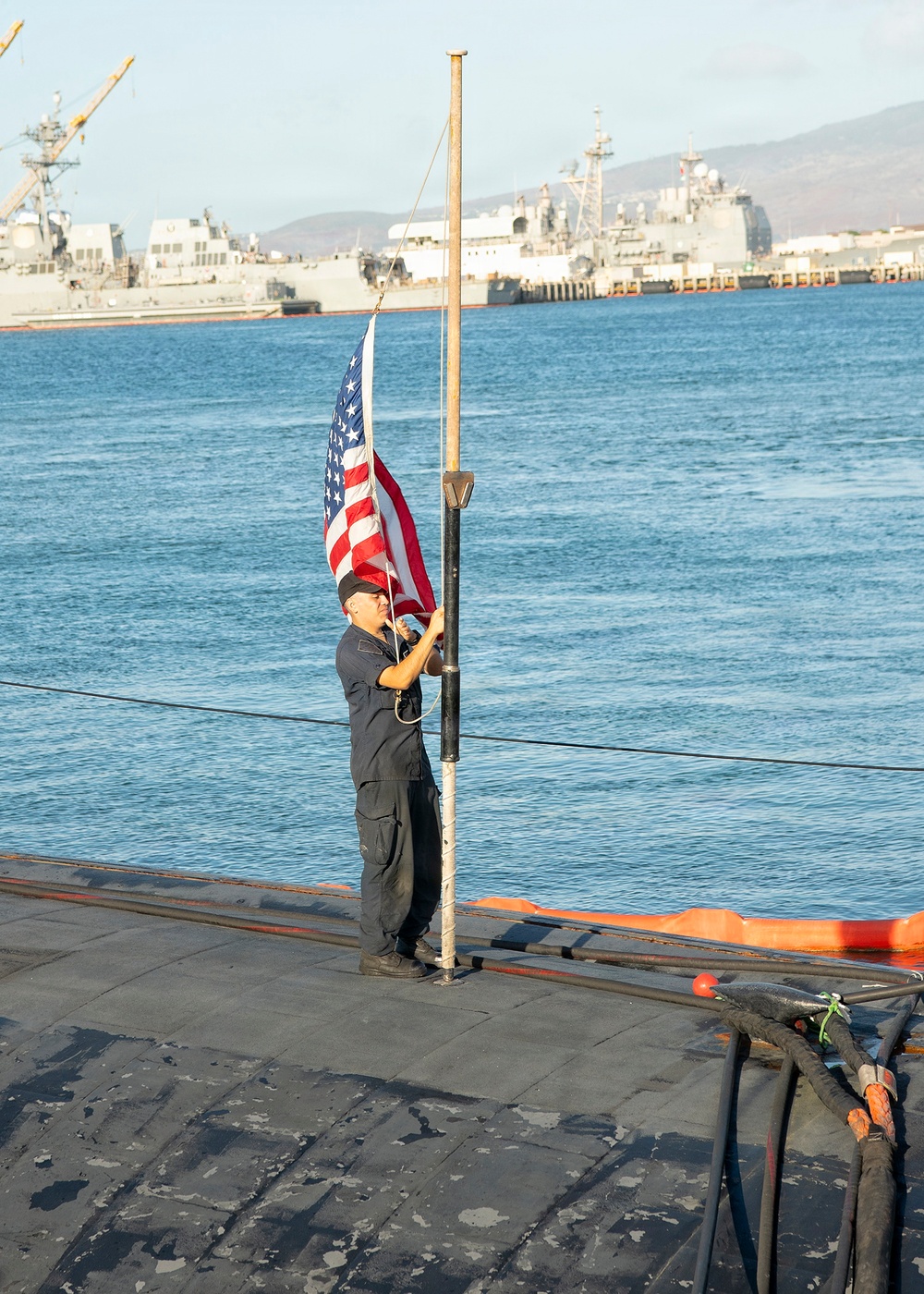 Sailor Honors Naval Tradition by Raising the Colors