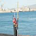 Sailor Honors Naval Tradition by Raising the Colors
