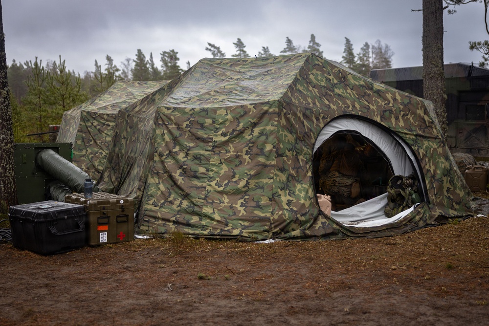 U.S. Navy Sailors alongside Finnish service members execute a simulated mass casualty response