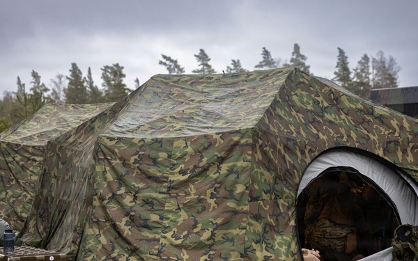 U.S. Navy Sailors alongside Finnish service members execute a simulated mass casualty response