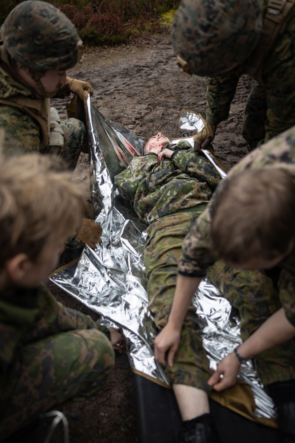 U.S. Navy Sailors alongside Finnish service members execute a simulated mass casualty response