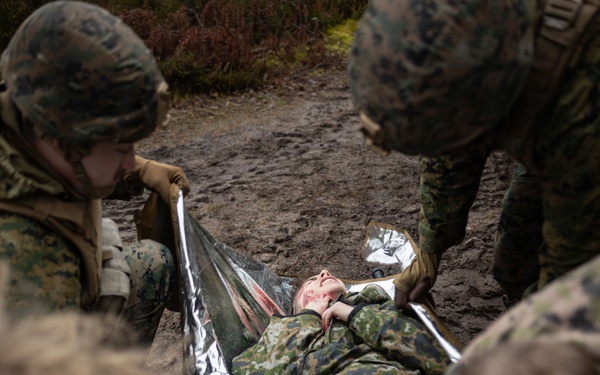 U.S. Navy Sailors alongside Finnish service members execute a simulated mass casualty response