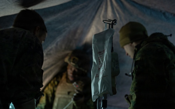 U.S. Navy Sailors alongside Finnish service members execute a simulated mass casualty response