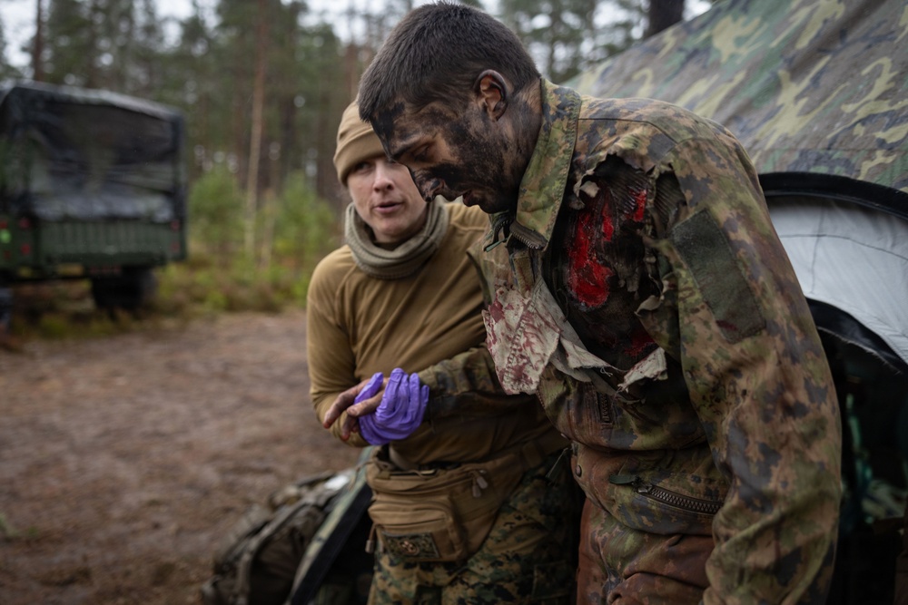 U.S. Navy Sailors alongside Finnish service members execute a simulated mass casualty response