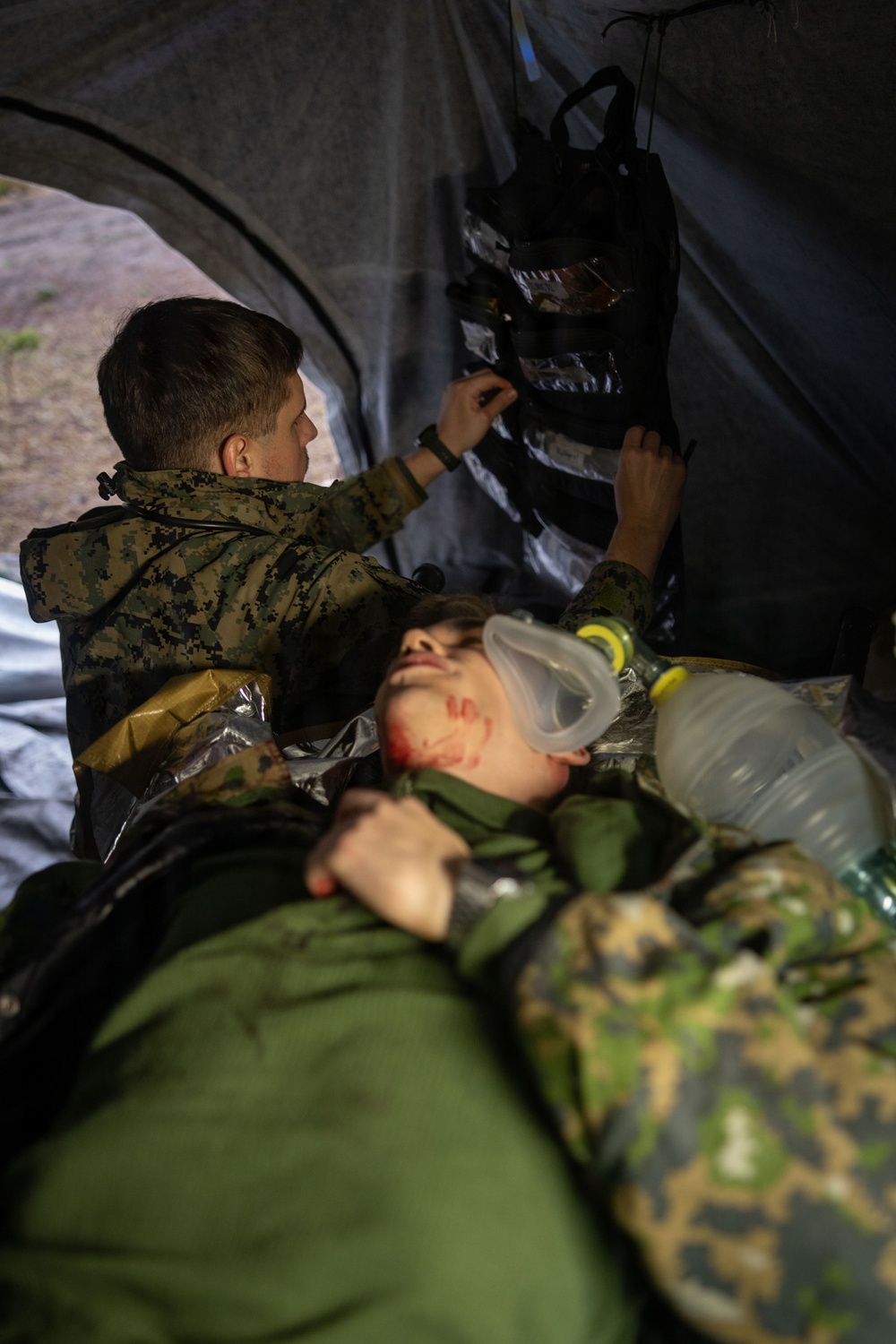 U.S. Navy Sailors alongside Finnish service members execute a simulated mass casualty response
