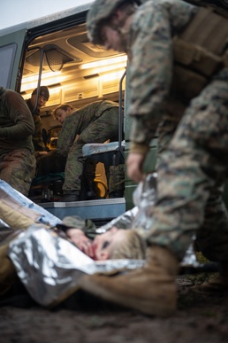 U.S. Navy Sailors alongside Finnish service members execute a simulated mass casualty response