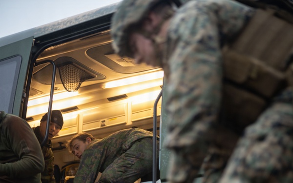 U.S. Navy Sailors alongside Finnish service members execute a simulated mass casualty response
