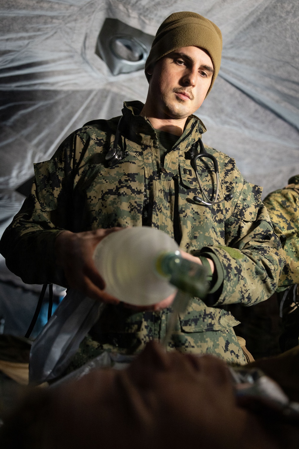 U.S. Navy Sailors alongside Finnish service members execute a simulated mass casualty response