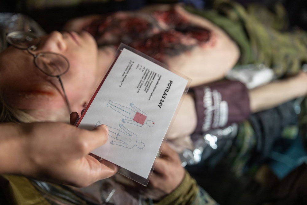 U.S. Navy Sailors alongside Finnish service members execute a simulated mass casualty response