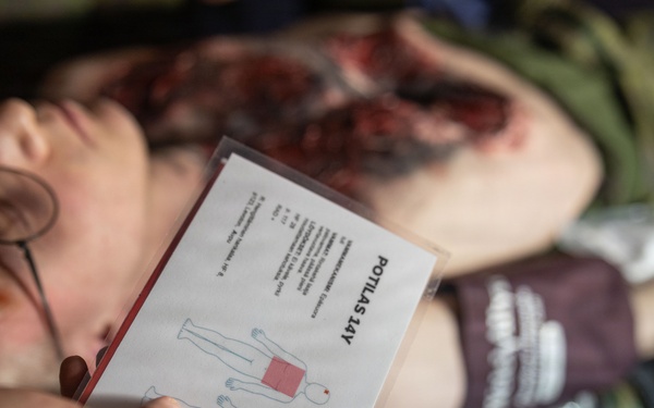 U.S. Navy Sailors alongside Finnish service members execute a simulated mass casualty response