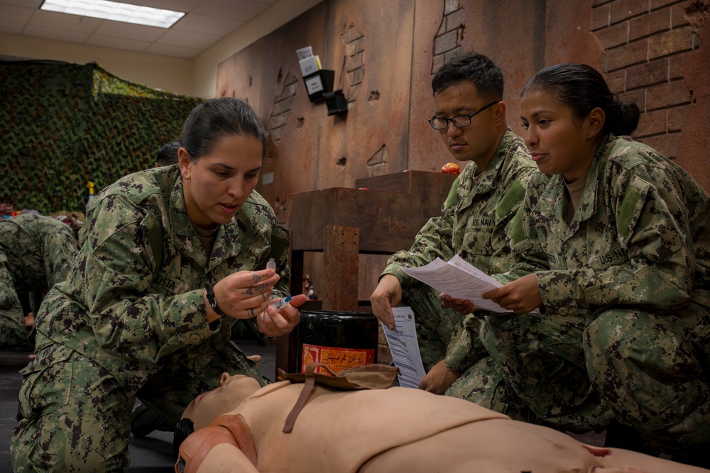 Sailors enrolled in the Hospital Corpsman Basic Course conduct combat lifesaver training.