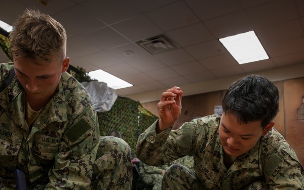 Sailors enrolled in the Hospital Corpsman Basic Course conduct combat lifesaver training.