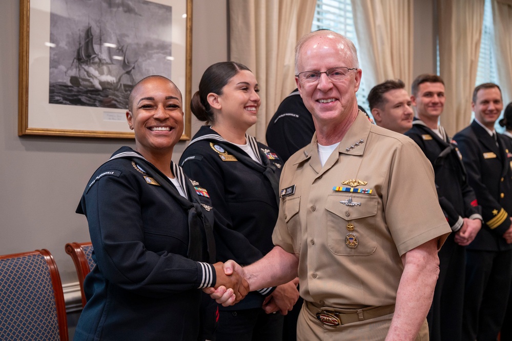 Adm. Daryl Caudle, Chief of Naval Operations, congratulates the fiscal year 2025 Recruiter of the Year awardees during a visit to the Pentagon