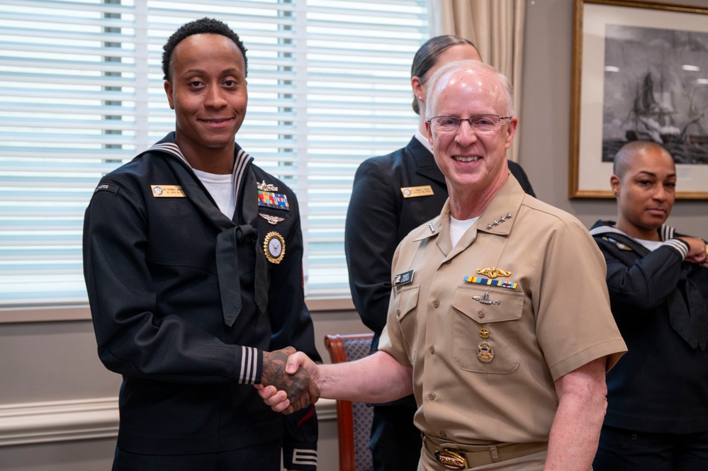Adm. Daryl Caudle, Chief of Naval Operations, congratulates the fiscal year 2025 Recruiter of the Year awardees during a visit to the Pentagon
