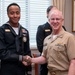 Adm. Daryl Caudle, Chief of Naval Operations, congratulates the fiscal year 2025 Recruiter of the Year awardees during a visit to the Pentagon