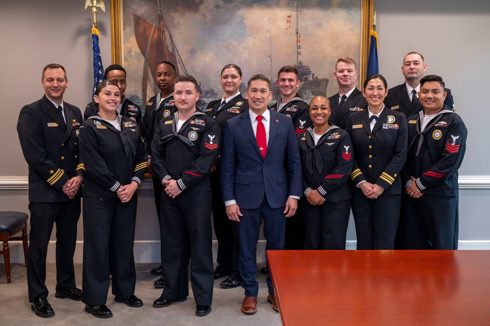 The Honorable Hung Cao, Under Secretary of the Navy, poses for a with the fiscal year 2025 Recruiter of the Year awardees during a visit to the Pentagon