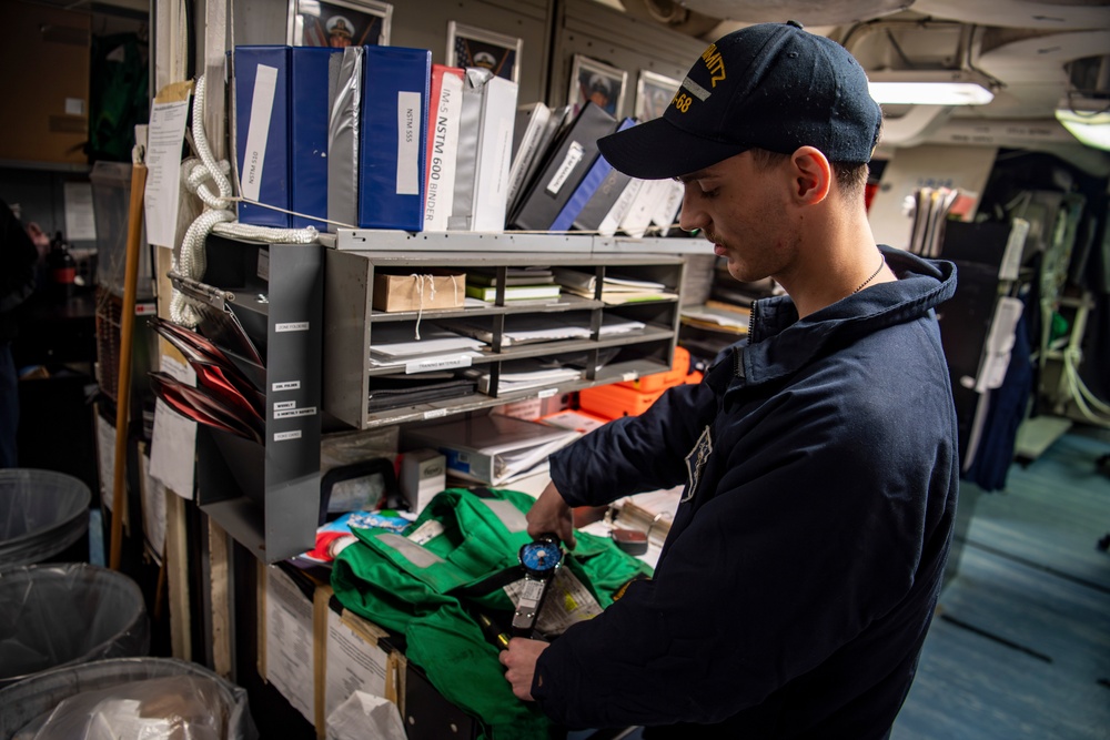 Nimitz Sailor Conducts Float Coat Maintenance