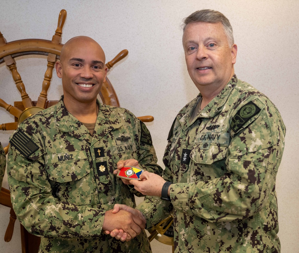 RADM Waters gives Bravo Zulu belt buckles to Chaplains