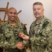 RADM Waters gives Bravo Zulu belt buckles to Chaplains