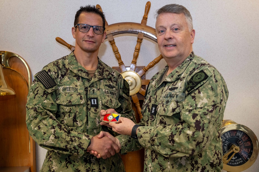 RADM Waters gives Bravo Zulu belt buckles to Chaplains