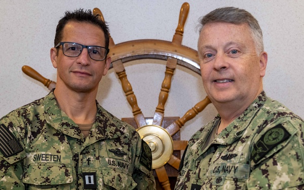 RADM Waters gives Bravo Zulu belt buckles to Chaplains