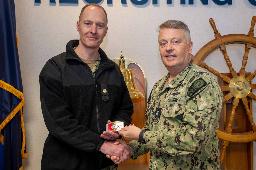 RADM Waters gives Bravo Zulu belt buckles to Chaplains