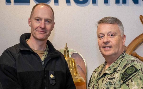 RADM Waters gives Bravo Zulu belt buckles to Chaplains