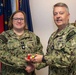 RADM Waters gives Bravo Zulu belt buckles to Chaplains