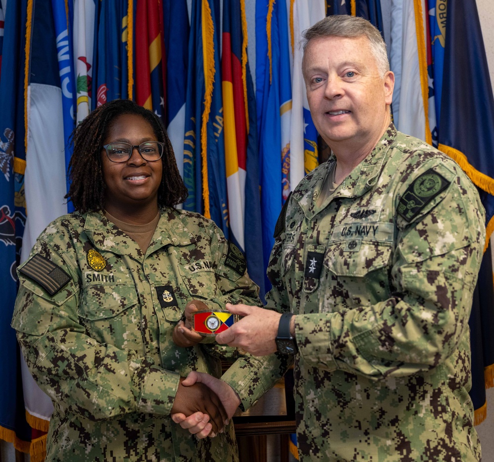 RADM Waters gives Bravo Zulu belt buckles to Chaplains