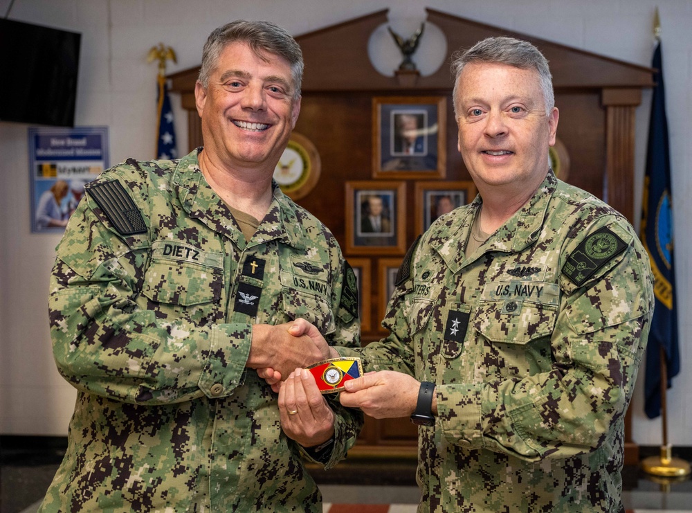 RADM Waters gives Bravo Zulu belt buckles to Chaplains