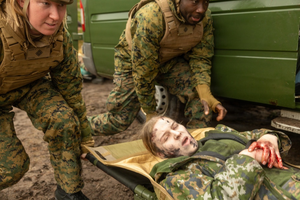 U.S. Navy Sailors alongside Finnish service members execute a simulated mass casualty response