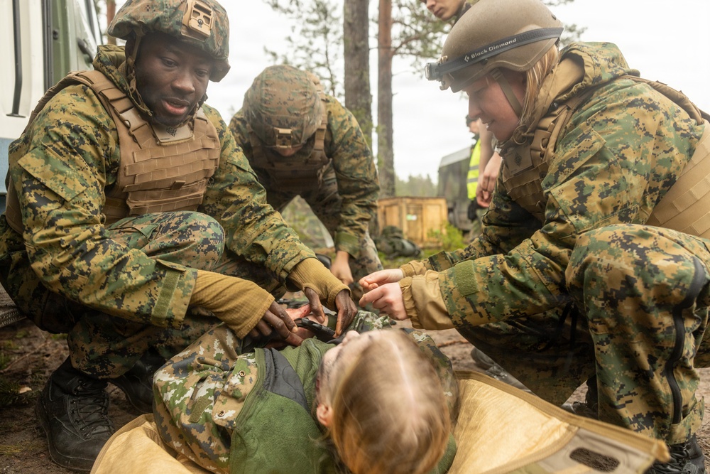 U.S. Navy Sailors alongside Finnish service members execute a simulated mass casualty response