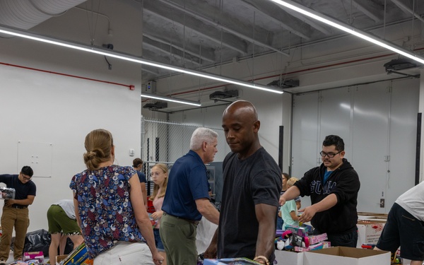 Service members help sort toys for Toys for Tots 2025