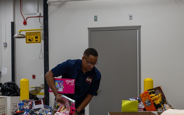 Service members help sort toys for Toys for Tots 2025