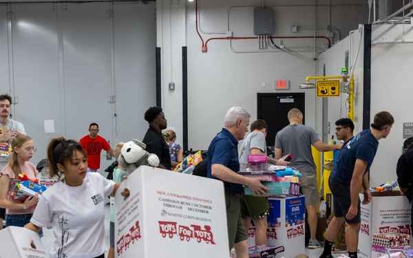 Service members help sort toys for Toys for Tots 2025