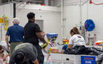 Service members help sort toys for Toys for Tots 2025