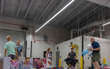 Service members help sort toys for Toys for Tots 2025
