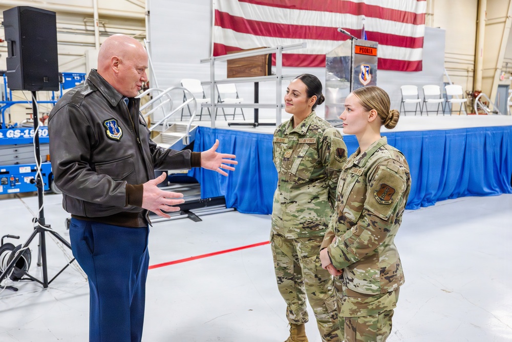 Airmen of Year winners get coined by Maj. Gen McDonough.