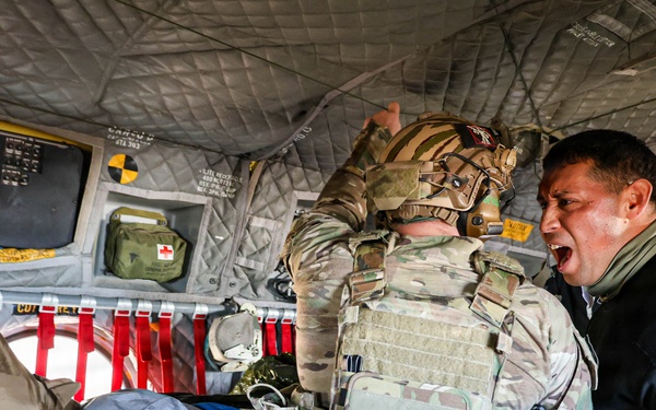 Medical Officer Guides SOF Civil Affairs Soldier Conducting Critical Combat Casualty Care in a Recent Combined Arms Field Exercise with a 82nd Airborne CH-47 Chinook Crew