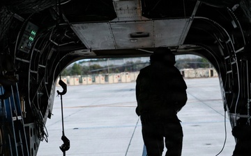 82nd Airborne CH-47 Chinook Crew Chief Prepares Ramp for Flight at a Combined Arms Field Exercise with SOF Civil Affairs