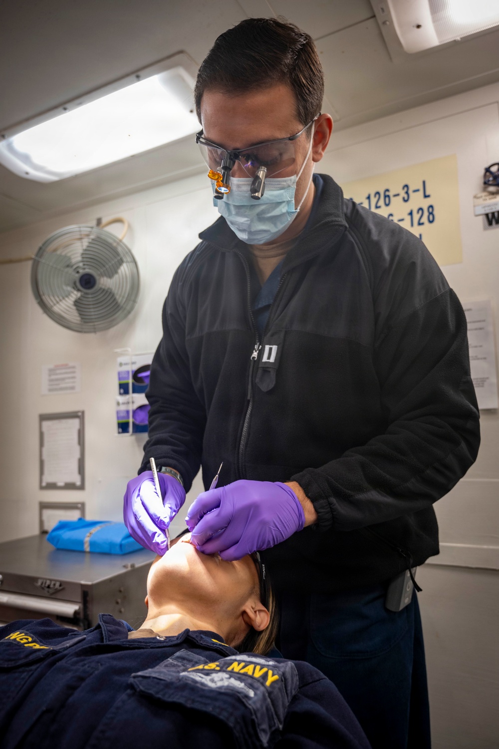 Sailor Performs A Dental Examination