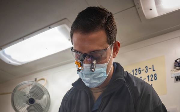 Sailor Performs A Dental Examination