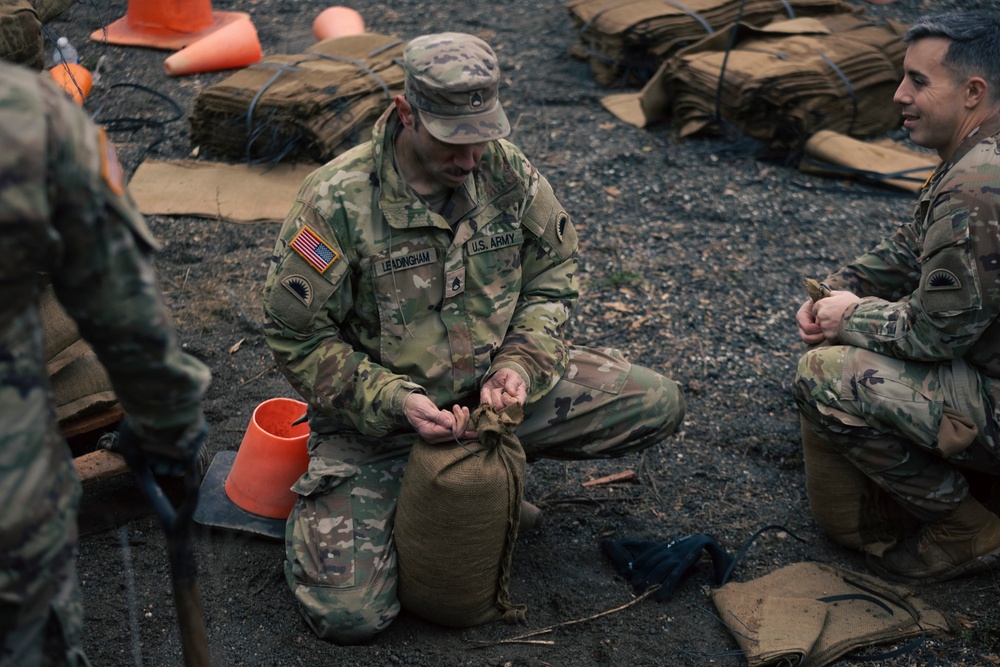 Guard personnel conduct sand bag filling operations in Skagit County