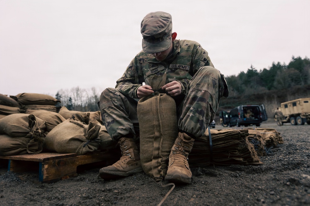 Guard personnel conduct sand bag filling operations in Skagit County