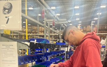 Future Sailor from NTAG ORV works on helmet for annual Army Navy game