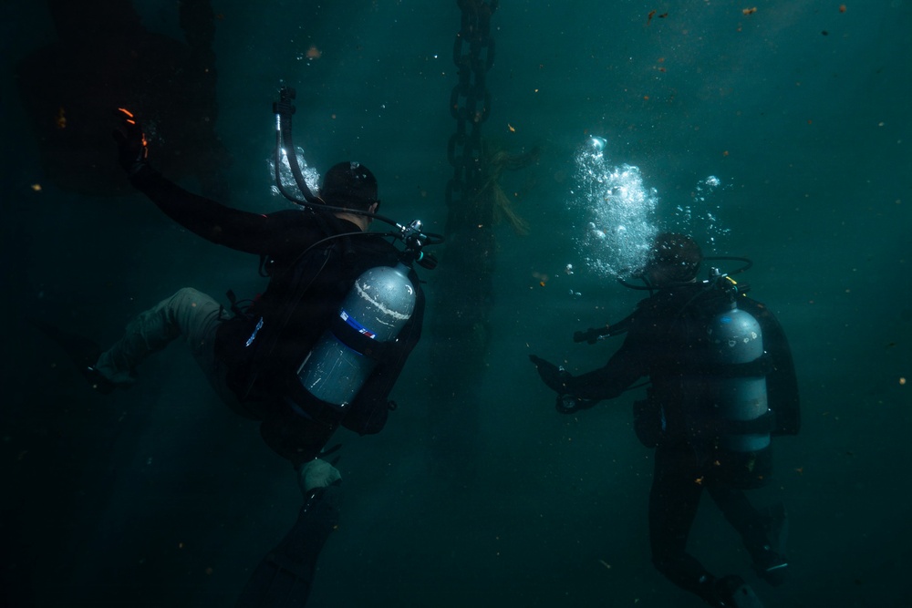 U.S. Coast Guard divers conduct aids to navigation operations