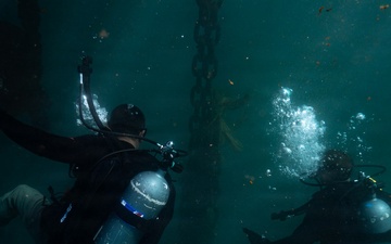 U.S. Coast Guard divers conduct aids to navigation operations